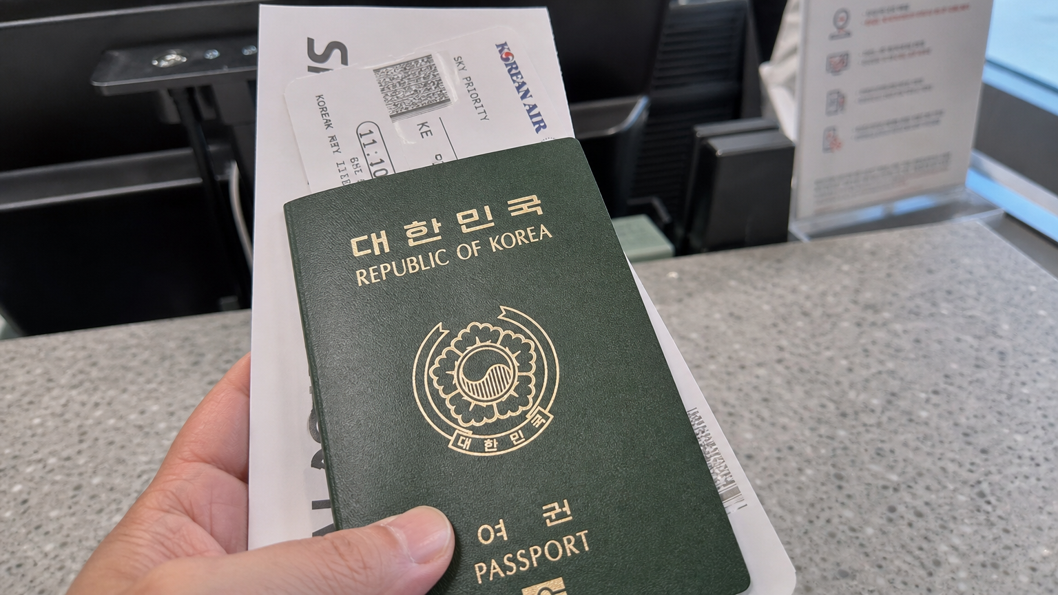 공항 카운터에서 한국 여권과 탑승권 등 여행 서류를 클로즈업한 모습