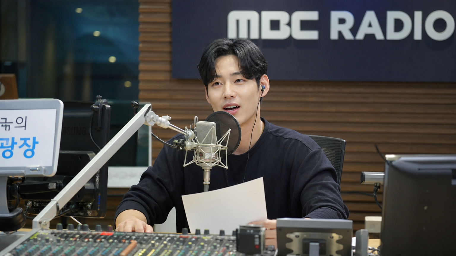 라디오 스튜디오에서 방송을 진행하는 한국 DJ의 모습
