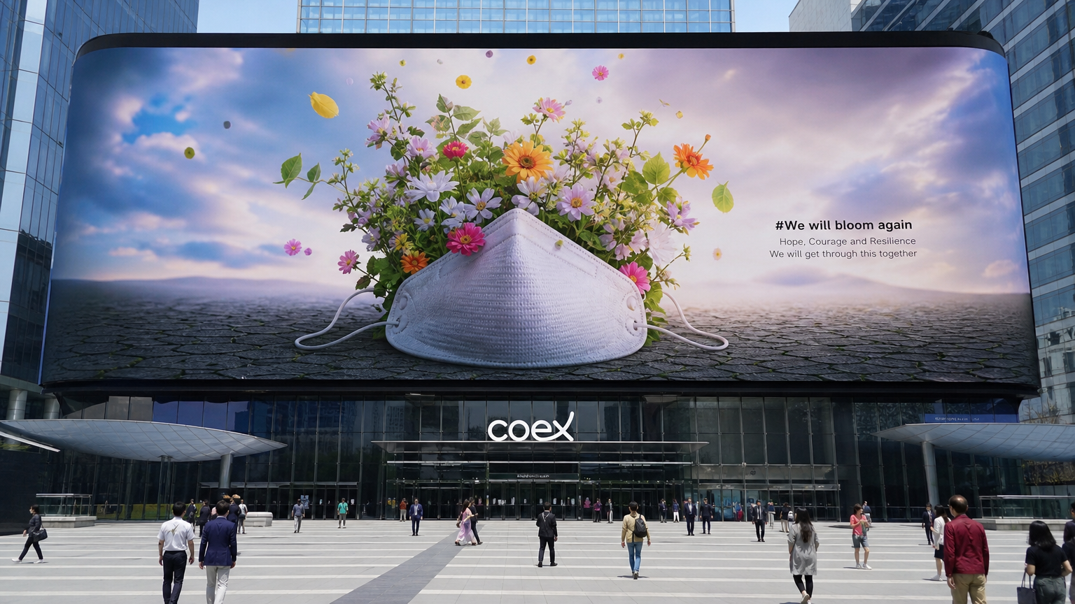 코엑스 대형 스크린에서 마스크를 벗고 피어나는 꽃의 상징적 메시지를 담은 장면