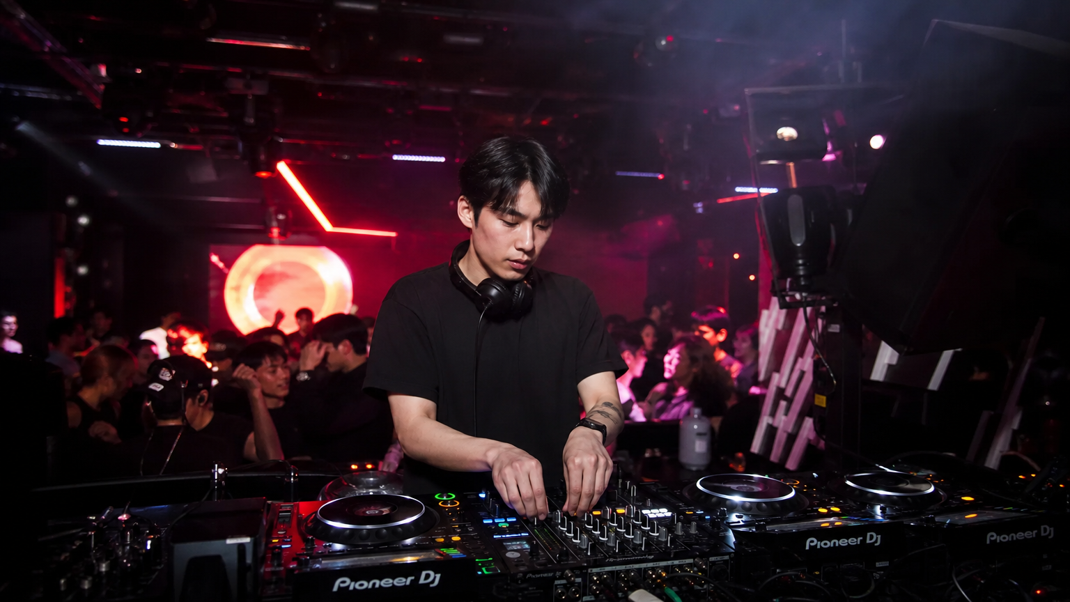 네온 조명 아래 트렌디한 클럽에서 음악을 믹싱하는 DJ