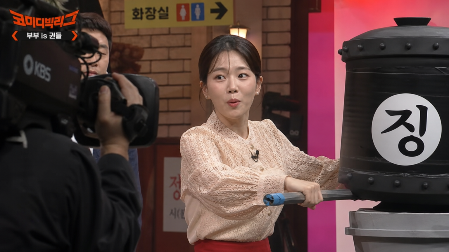예능 프로그램 세트장에서 코미디 연기를 펼치는 여배우의 현장감 있는 모습